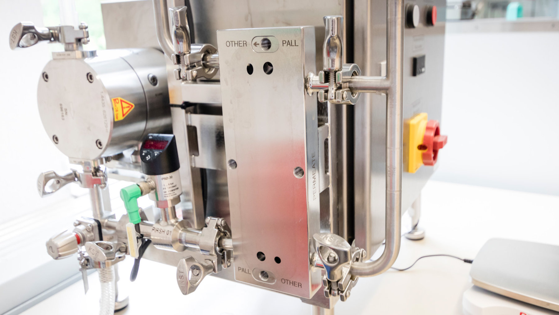This image depicts a close-up view of an industrial valve assembly with several labeled control switches marked with options like "other," "full," and "pall." The valves feature numerous pipelines and a control panel with directional adjustments and a prominent cautionary warning label.