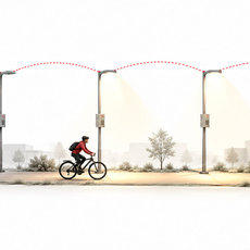 Ein Radfahrer fährt nach rechts durch eine Straße mit bedarfsgerecht aufgehellten Leuchten.