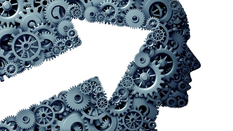 Ein menschliches Profil, das aus ineinandergreifenden Zahnrädern unterschiedlicher Größen gebildet wird, symbolisiert komplexe Zusammenhänge oder Mechanismen.