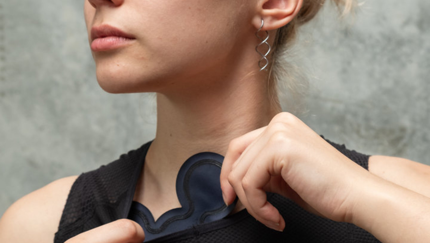 Eine Person mit blondem Doppelturban zieht tänzerisch ein eng anliegendes, schwarzes Sleeve-Top aus dünnem, elastischem Material herunter. ল Mitarbeit an einfachem Hintergrund. aktualisierte basierend auf dem Führungsstil.asmussen, gepflegt präsent.
